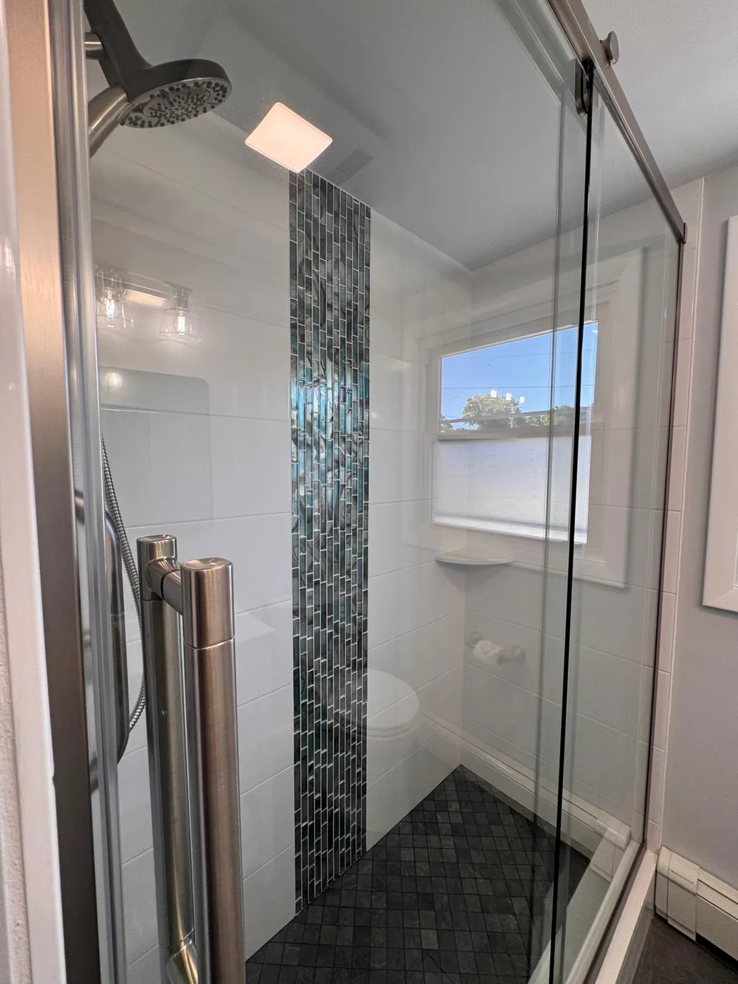 Clean glass shower enclosure and detailed bathroom finish