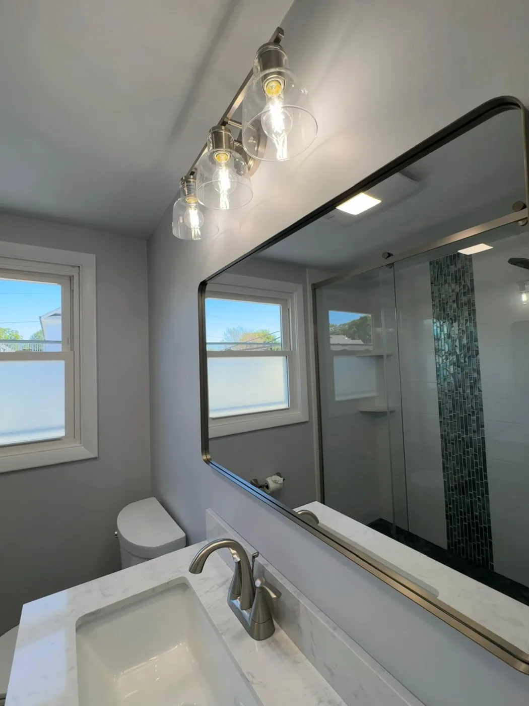Bright bathroom vanity and mirror after cleaning