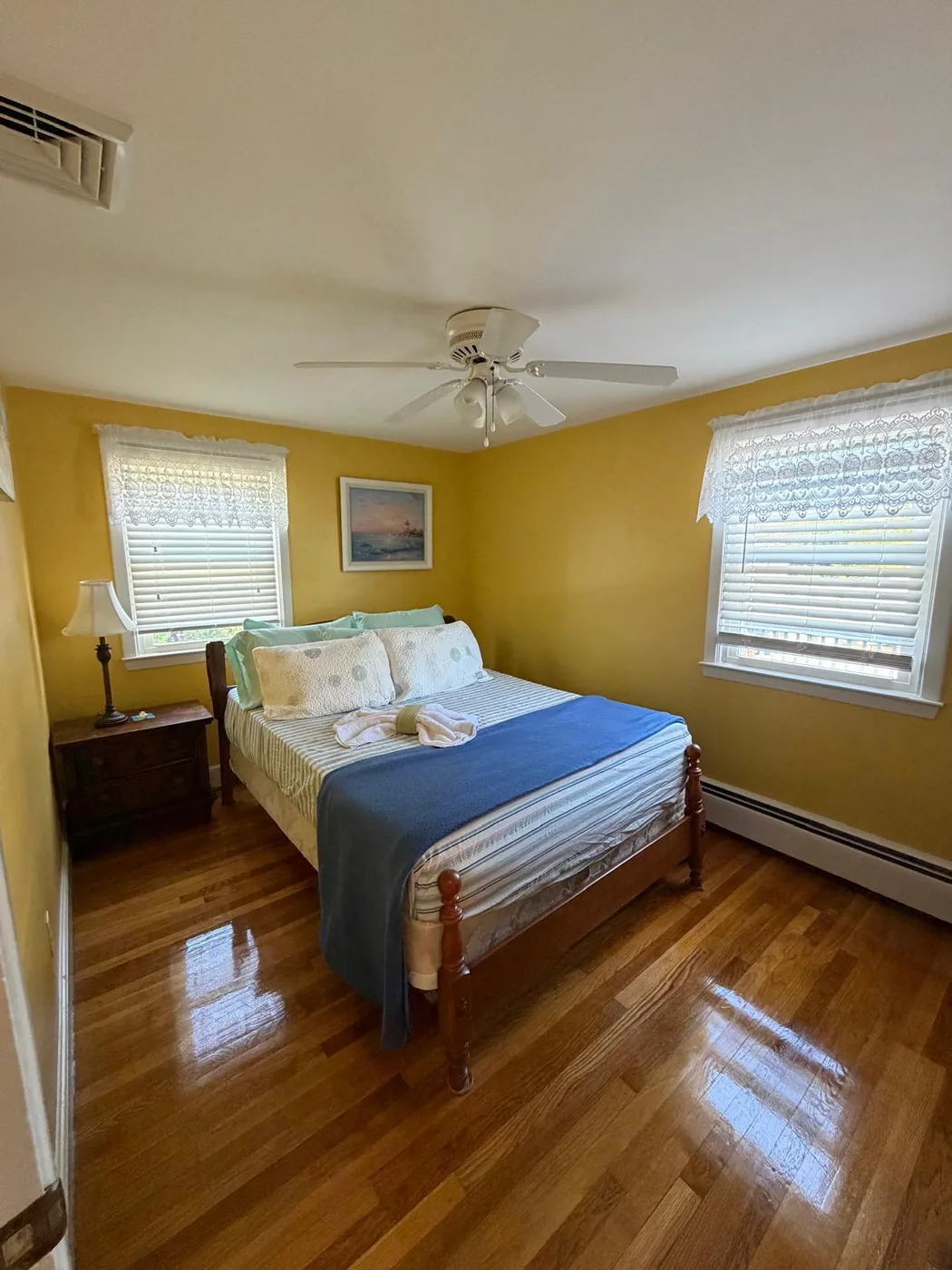 Finished bedroom with polished hardwood floors after cleaning